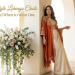 A woman in an orange and white jacket style lehnga choli stands beside a wall, showcasing traditional Indian attire.
